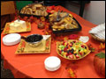 cold catered breakfast table with fruit salad and bagels