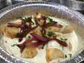 individually packaged vegetarian meals with potato pierogis in truffle cream sauce, topped with caramelized onions