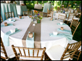 The tables are dressed in mint and burlap for a catered backyard wedding on Long Island