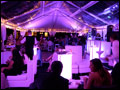 People having a good time at a catered Long Island wedding and drinking cocktails at a lounge area next to the dance floor
