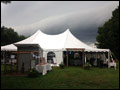 Storm clouds over a wedding tent at a catered Long Island farm wedding, the tent offers shelter to the guests as the rain moves in